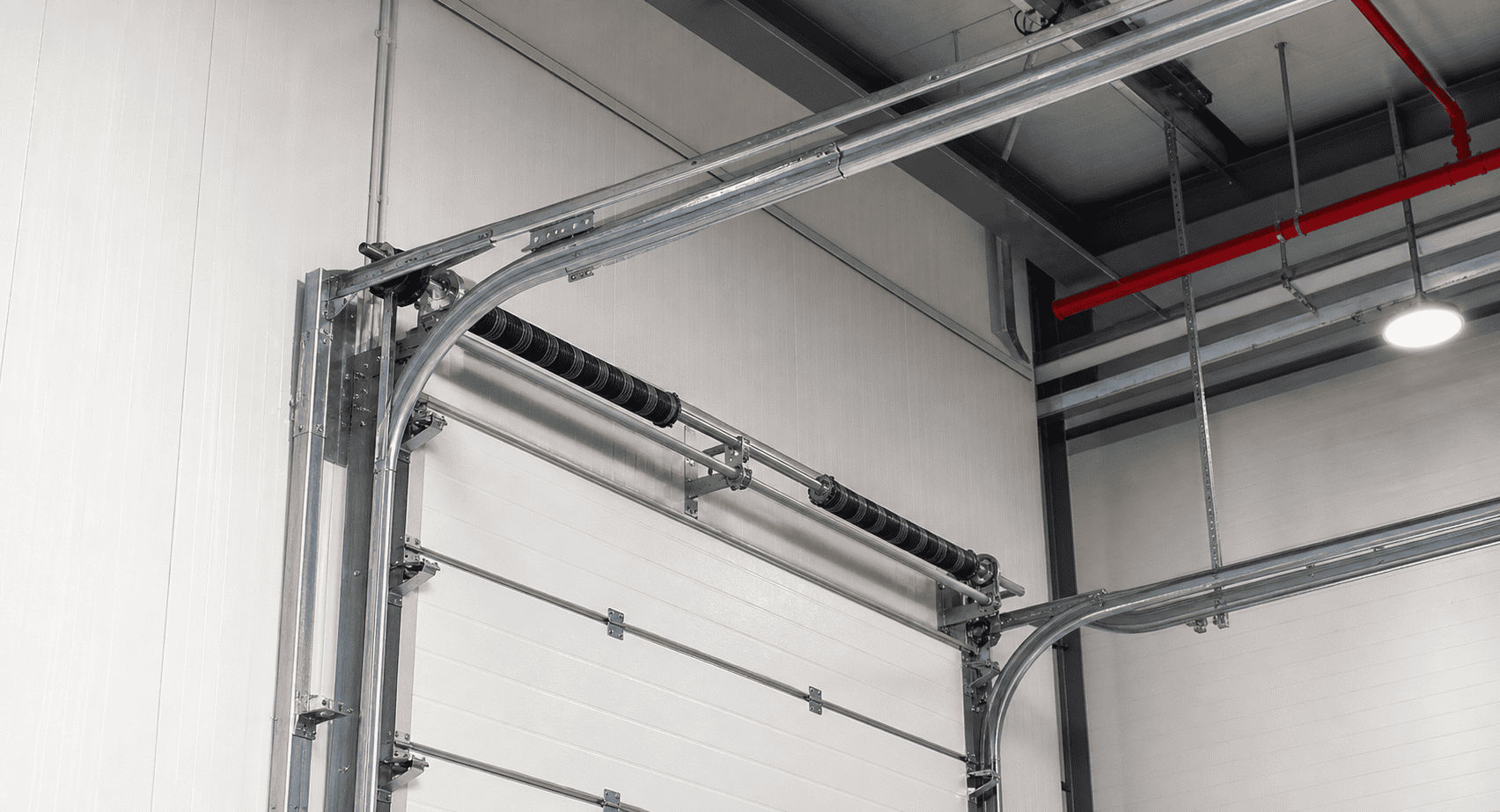 high lift sectional door track system rising higher before turning under roof
