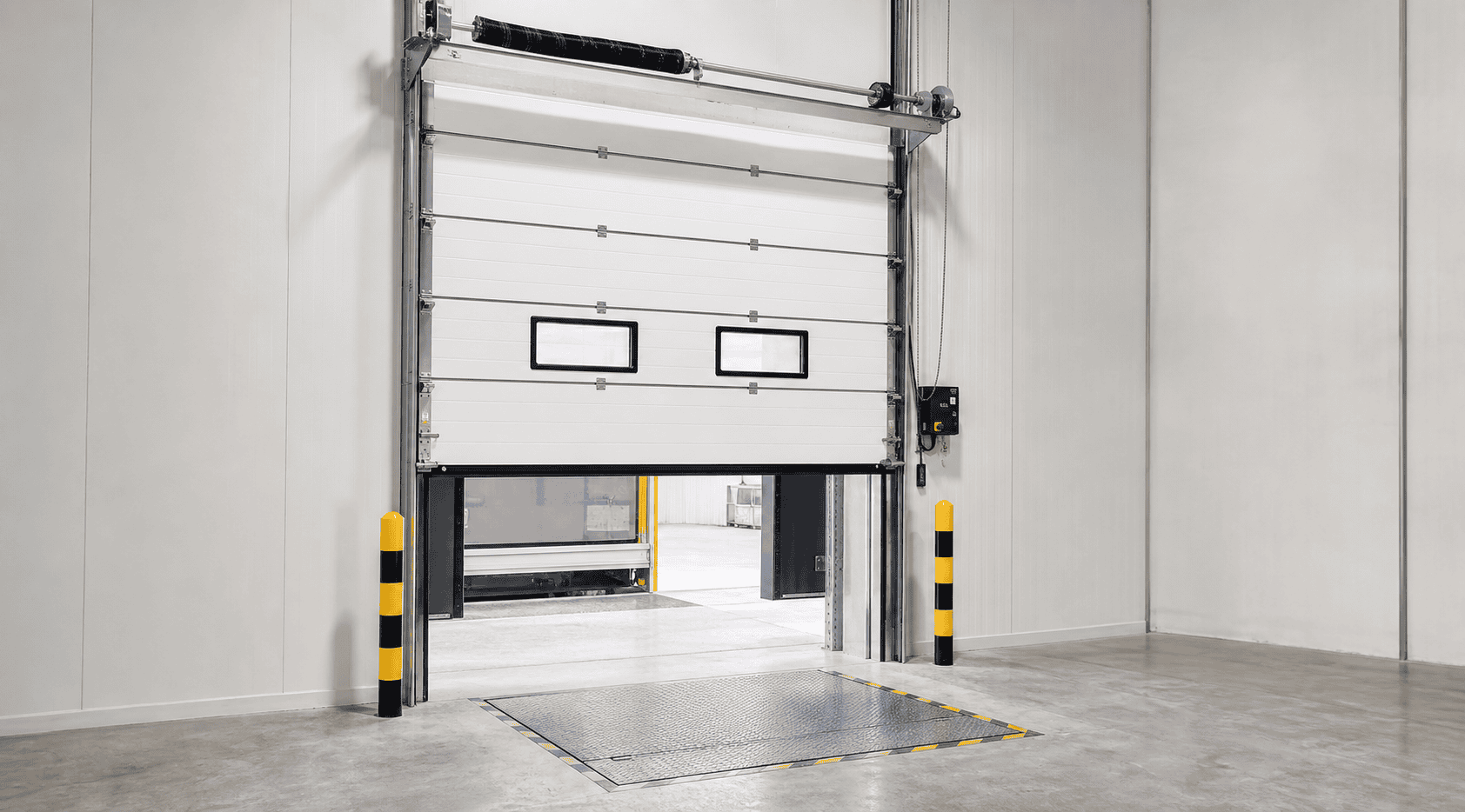 insulated sectional overhead door with dock leveler and dock shelter system